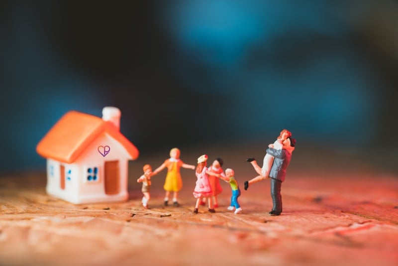 small figurines showing family celebrating as they have a new house