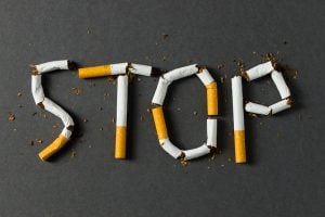 Sign saying "stop" made out of cigarettes