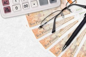 ten pound notes with glasses and calculator 