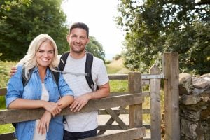 uk couple standing outside a gate in the uk countryside