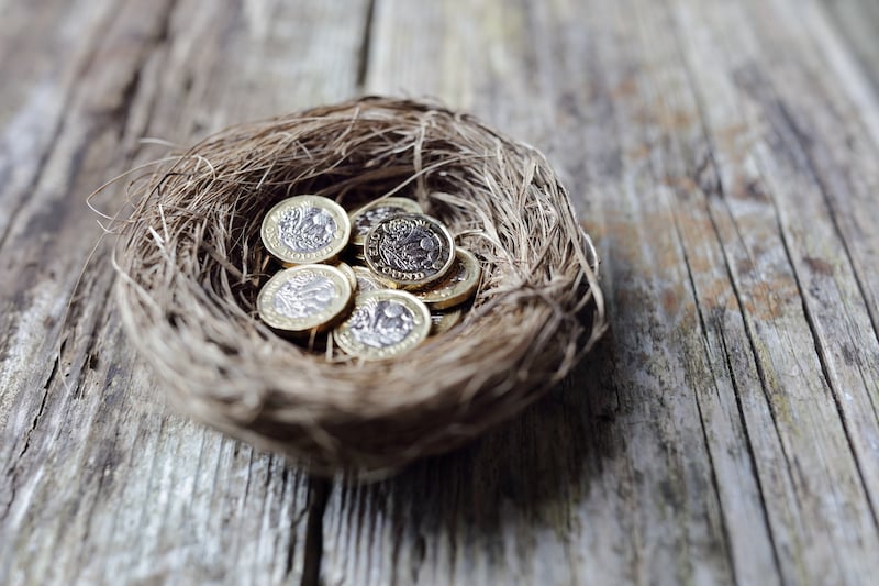 a nest full of new british pound coins representing an additional payment