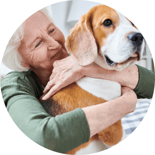 Older lady hugging dog
